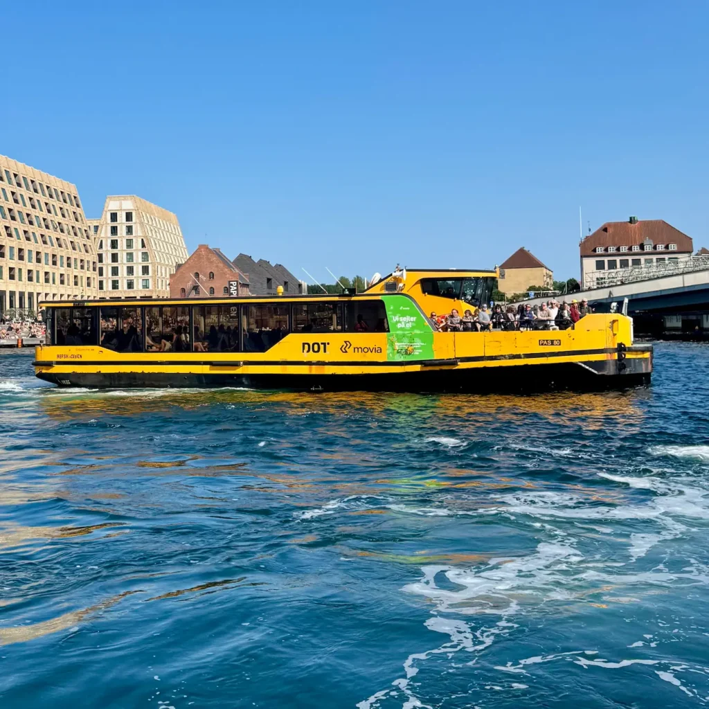 Yellow Harbor Bus sailing past Christianshavn in Copenhagen harbor